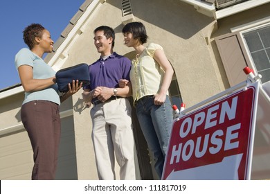 Real Estate Agent With Couple Buying New House