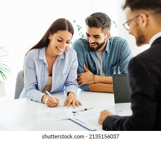 Real estate agent with couple closing a deal and signing a contract