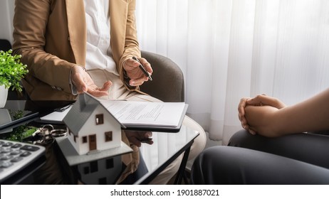 Real estate agent and customer discussing for contract to buy, get insurance or loan real estate or property. - Shutterstock ID 1901887021