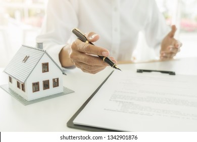 Real estate agent and customer signing contract to buy house, insurance or loan real estate. - Shutterstock ID 1342901876