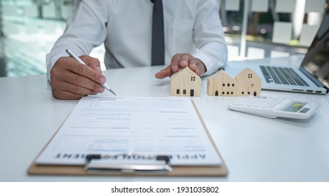 Real estate agent and customer signing contract to buy house, insurance or loan real estate.rent a house,get insurance or loan real estate or property. - Shutterstock ID 1931035802