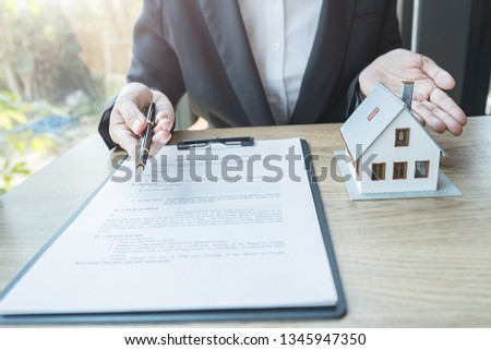 Real estate agent and customer signing contract to buy house, insurance or loan real estate.