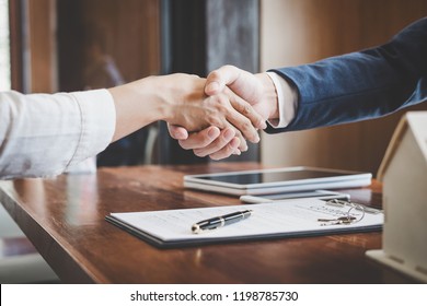 Real estate agent and customers shaking hands together celebrating finished contract after about home insurance and investment loan, handshake and successful deal. - Shutterstock ID 1198785730