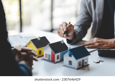 real estate agent Delivering sample homes to customers, mortgage loan contracts. Make a contract for hire purchase and sale of a house. and home insurance contracts, home mortgage loan concepts - Shutterstock ID 2307646429