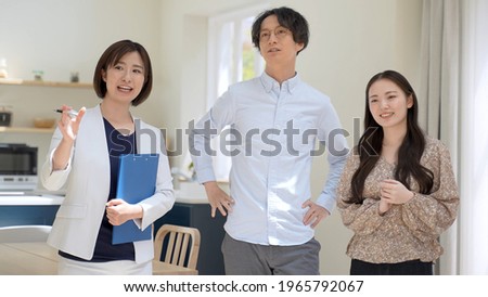 real estate agent explaining to couple in the house