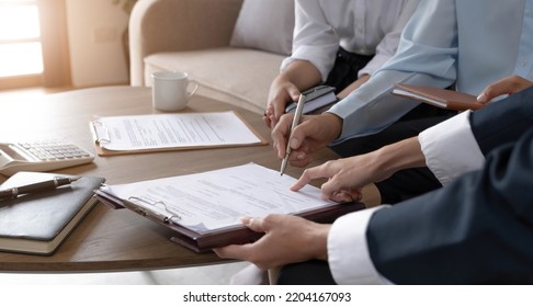 Real estate agent explaining and let customers sign a house purchase contract, discussing for contract to buy house, real estate concept and background. - Shutterstock ID 2204167093