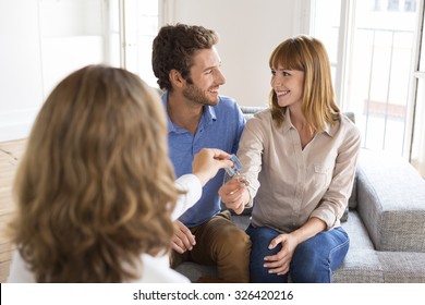 Real Estate Agent Giving House Keys To New Owners