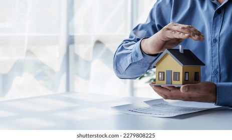 real estate agent Hand over the keys and the model house to the customer and the home insurance contract. home mortgage loan concept - Shutterstock ID 2279808225