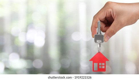 Real Estate Agent Handing Over A House Keys In Hand, And Coins