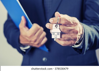 Real Estate Agent Handing Over House Keys 