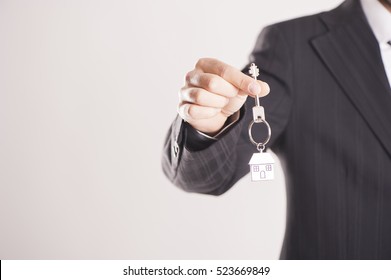 Real Estate Agent Handing Over House Keys 