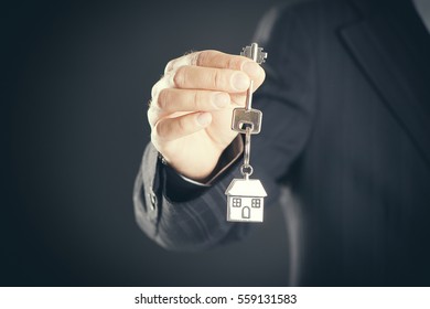 Real Estate Agent Handing Over House Keys 