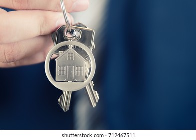 Real Estate Agent Holding Key Of New Apartment Close Up. Realestate Key Real Estate House Security Home Deal Concept