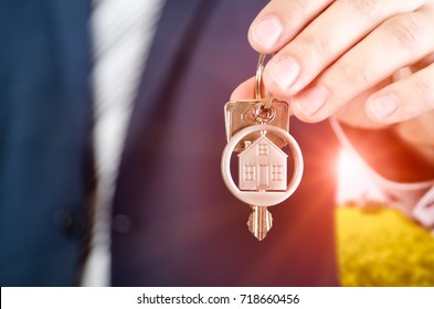 Real Estate Agent Holding Key Of New Apartment Close Up. Realestate Key Real Estate House Security Home Deal Concept