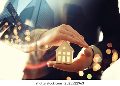 Real estate agent holding toy house - Powered by Shutterstock