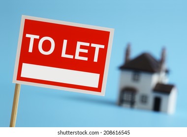 Real Estate Agent To Let Sign With House In Background