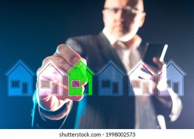 Real Estate Agent Man Manages Virtual Screen. Blurred Real Estate Agent Man In Background. Male Realtor Chooses A House. He Selects A Property To Purchase. Property Insurance And Security Concept.