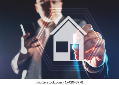 Real Estate Agent. Realtor Pulls To The House Icon On Virtual Screen. Blurred Real Estate Agent In Background. Real Estate Agent Career Concept. Man Works In A Realtor Agency. Selection Of Realtor