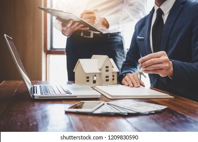 Real estate agent and Sales manager team analysis pricing of rental lease contract of sale purchase agreement, concerning mortgage loan offer for and house insurance. - Shutterstock ID 1209830590