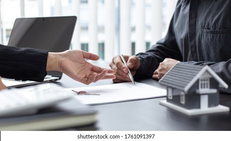 Real estate agent or sales manager has proposed terms and conditions to customers who sign house purchase agreements with insurance, Agreement to sign the purchase contract concept.