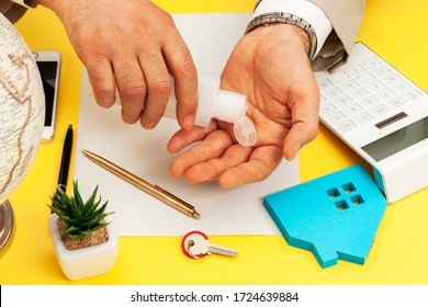 A Real Estate Agent Sanitizes His Hands During The COVID-19 Virus