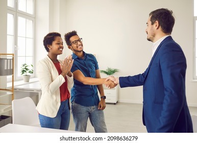 Real Estate Agent Shake Hand Of Excited Couple Congratulate With Home Purchase Or Buy. Realtor Or Broker Handshake Buyers Or Clients Greeting With House Ownership. Rental, Realty Concept.