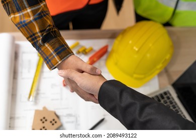 Real Estate Agent Shakes Hands With Construction Team Leader. Business Agrees To Sign A Home Builder After Engineer Shows Model Building Project. Mortgage, Rent, Buy, Sell, Purchase,move,Selling Home.