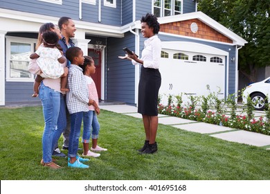 Real Estate Agent Showing A Family A House