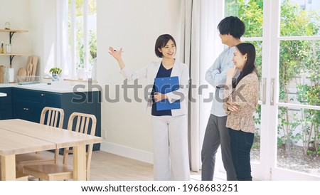 Real estate agent showing house interior for asian couple.