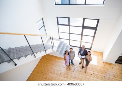Real estate agent showing new house to couple with digital tablet - Shutterstock ID 400680337