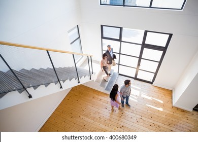 Real estate agent showing new house to couple - Shutterstock ID 400680349