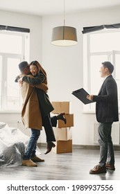 Real Estate Agent Shows Bright New Apartment To A Young Couple