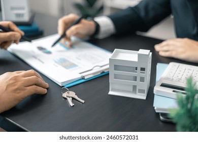 Real estate agent, skilled in finance and business, took on residential project with broker's guidance, securing apartments with confident hand in market. Lawyer negotiated business deal for building - Powered by Shutterstock