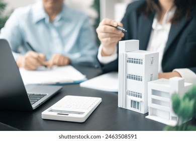 Real estate agent, skilled in finance and business, took on residential project with broker's guidance, securing apartments with confident hand in market. Lawyer negotiated business deal for building - Powered by Shutterstock