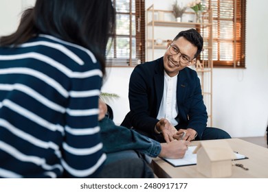 Real Estate Agent Smiling While lgbt lesbian Couple Client Signs Contract for New Home Purchase in Modern Office Setting - Powered by Shutterstock