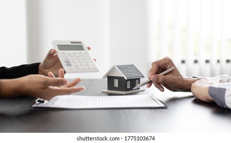 Real estate agent talked about the terms of the home purchase agreement and asked the customer to sign the documents to make the contract legally, Home sales and home insurance concept. - Shutterstock ID 1775103674