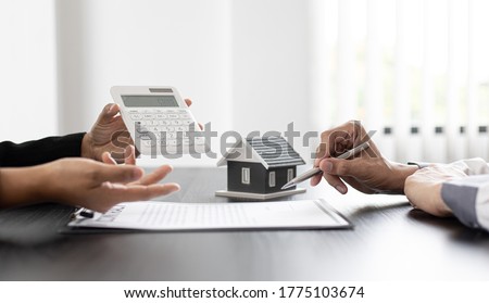 Real estate agent talked about the terms of the home purchase agreement and asked the customer to sign the documents to make the contract legally, Home sales and home insurance concept. Сток-фото © 