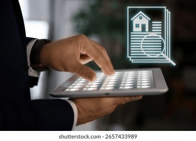 Real estate agent using tablet computer, closeup. House data and magnifying glass on virtual screen