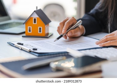 Real Estate Agent Working Sign Agreement Document Contract For Home Loan Insurance Approving Purchases For Client With House Model.