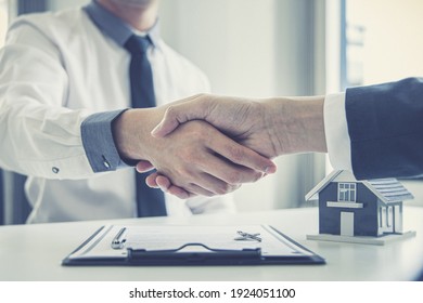 Real estate agents and customers shake hands to congratulate on signing a contract to buy a house with land and insurance, handshake and Good response concept.