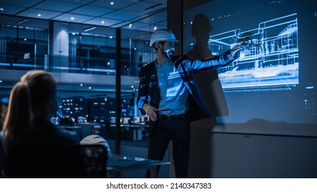 Real Estate Architectural Conference Meeting. Portrait of Chief Architect Presenting Building Construction to Investors. Projector TV Screen in Dark Room Shows 3D Model of Sustainable Housing Project - Powered by Shutterstock