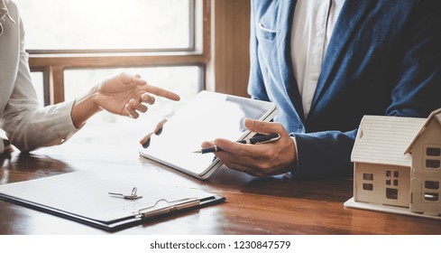 Real Estate Broker Agent Presenting And Consult To Customer To Decision Making Sign Insurance Form Agreement, Home Model, Concerning Mortgage Loan Offer For And House Insurance.