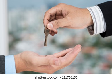 Real Estate Broker Giving The Key To The Client