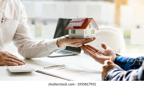 A real estate broker recommends house types and making contracts for sale and rent. - Shutterstock ID 1955817931