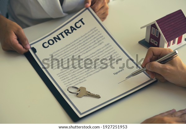 Real estate brokerage\
agent Contract, agreement, home insurance concept Making lease and\
buying a house