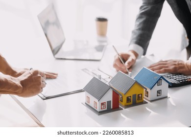 Real estate brokerage agent Deliver a sample of a model house to the customer, mortgage loan agreement Making lease and buying a house And contract home insurance concept