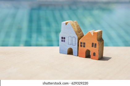 Real Estate Business Concept, Miniature House With Space On Swimming Pool Background, Outdoor Day Light