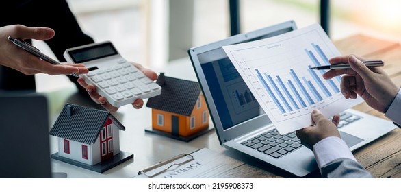Real estate business concept A rental company employee is calculating the cost for the customer to agree to sign a title contract by explaining the terms and conditions of sale.
