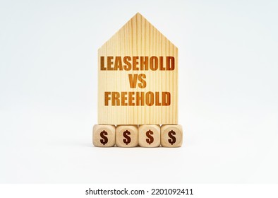 Real Estate And Business. On A White Surface Stands A Wooden Model Of A House With The Inscription - Leasehold Vs Freehold