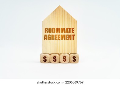 Real Estate And Business. On A White Surface Stands A Wooden Model Of A House With The Inscription - Roommate Agreement